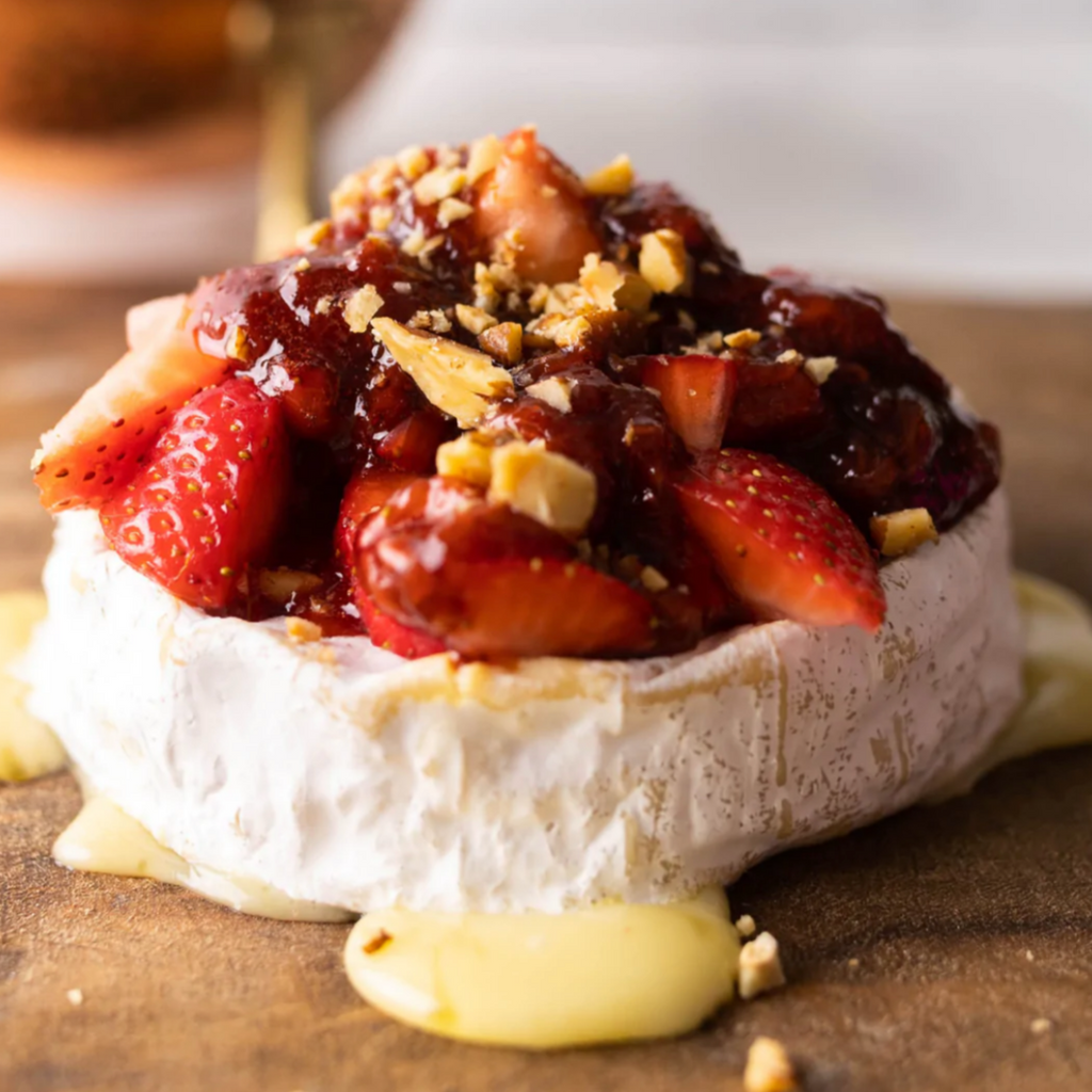 Baked Green Hill cheese with strawberries and almonds